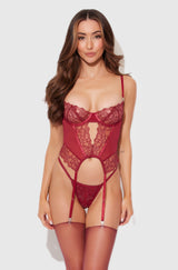 Woman wearing a red lace lingerie set on a white background