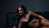 Exquisite black lace Lauren Cutout Thong Panty and matching bra on a model.